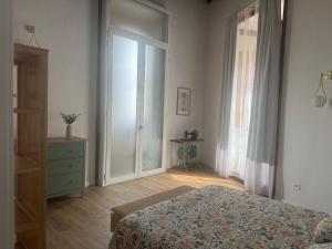 a bedroom with a bed and a dresser and a window at Casita La Mercería in Güimar