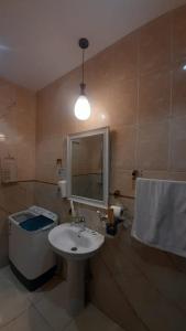 a bathroom with a sink and a toilet and a mirror at دريم لاند صامطة - Dream Land Samtah in Şāmitah +42 photos