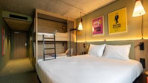 a bedroom with a bed and a bunk bed at greet Hotel Reims Tinqueux in Reims