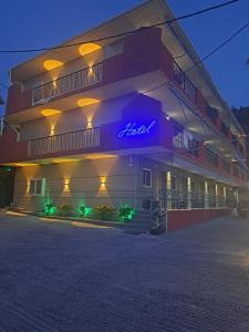 a building with a neon sign on the side of it at Hotel Vasilis Nafplio in Nafplio