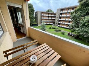 a wooden bench sitting on the balcony of a building at Langgrütstrasse 21, 8047 Zürich, Switzerland in Zürich