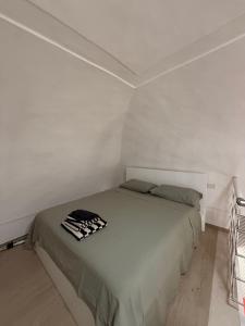 a bedroom with a bed in a white room at The Dream Home in Vieste