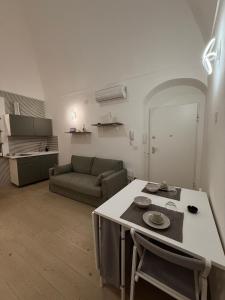 a kitchen and living room with a table and a couch at The Dream Home in Vieste