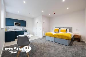 a bedroom with a king sized bed and a kitchen at Morecambe Bay Stays in Morecambe +9 photos