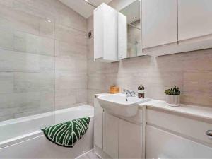 a bathroom with a sink and a tub and a mirror at Drovers Lodge, farm retreat in rural Lanarkshire, family and pet friendly, onsite craft distillery, perfect location for exploring central Scotland in Forth +14 photos