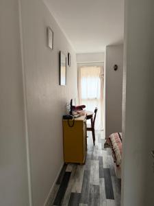 a room with a desk and a table with a laptop at La Résidence du Moulin in Jonzac