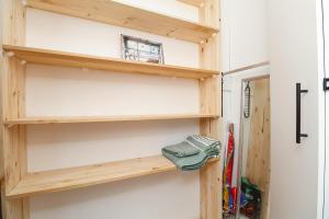 a room with wooden shelves next to a door at Dune Sanctury in Keurboomstrand