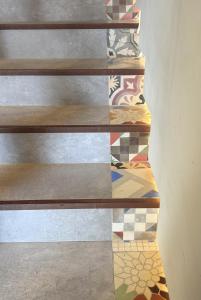a set of stairs with colorful tiles on them at Pou by Seaward Suites in Villajoyosa