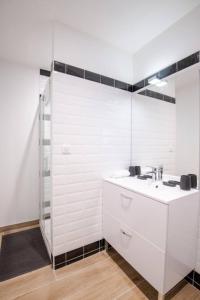 a white bathroom with a sink and a mirror at La Maison Renaissance Amboise 4 bedroom house in Amboise +9 photos