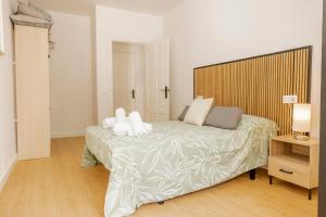 a bedroom with a large bed with white pillows at Apartamento en centro de Cazorla con vista a la montaña in Cazorla
