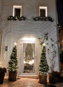 a house with two christmas trees in front of a door at 1783 Dimora d'Epoca in Locorotondo