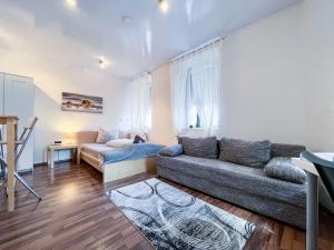 a living room with a couch and a table at AugsburgLiving - Business- und Ferienapartments in Augsburg