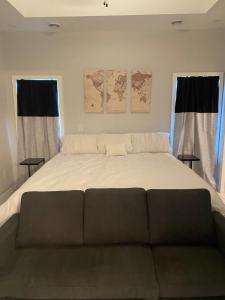 a large bed in a room with two windows at Newly built home in Superior Duluth area in Superior