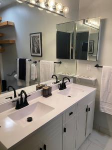 a bathroom with two sinks and a large mirror at Newly built home in Superior Duluth area in Superior