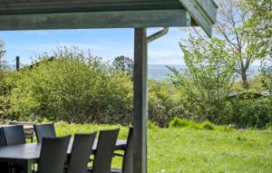 a table and chairs with a view of a field at Nice Home In Sydals With Wifi in Høruphav +20 photos