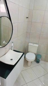 a bathroom with a toilet and a sink and a mirror at Apto 5 pessoas - Prox FIP e Stop Shop in Brusque +11 photos