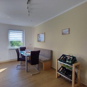 a living room with a table and a couch at Ferienwohnung Lindeneck in Neusitz +7 photos