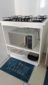 a microwave oven with a stove on top of it at Apto 5 pessoas - Prox FIP e Stop Shop in Brusque