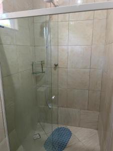 a shower with a glass door in a bathroom at Apto 5 pessoas - Prox FIP e Stop Shop in Brusque