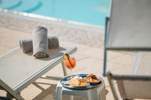 a plate of food on a table next to a chair at Hotel Carignano in Lucca +166 photos