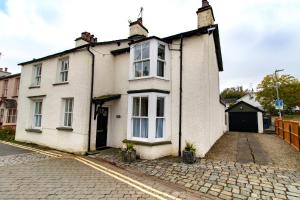 an old white house on a cobblestone street at Wansfell View, Central Hawkshead with Hot Tub in Hawkshead