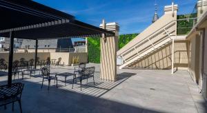 un patio con sillas y mesas y una escalera en Fliphaus Moreno 550 'A' Loft with Pool in Plaza de Mayo, en Buenos Aires