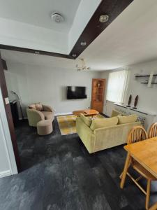 a living room with two couches and a table at 3 bedroom apartment in Ulverston Cumbria in Ulverston