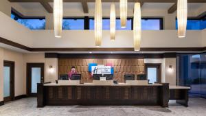 a woman is standing at a podium in a lobby at Holiday Inn Club Vacations Scottsdale Resort in Scottsdale +141 photos