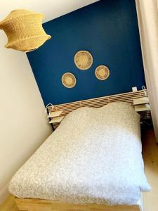 a bed in a room with coins on the wall at Appartement Hyper centre refait à neuf in Luchon