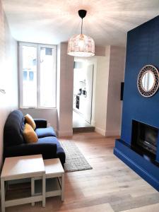 a living room with a couch and a fireplace at Appartement Hyper centre refait à neuf in Luchon