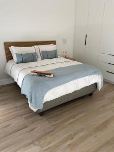 a bedroom with a large bed with a wooden floor at Sunny Side Haven in Faure