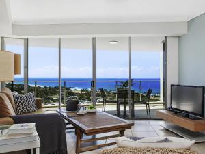 a living room with a view of the ocean at The Sebel Maroochydore in Maroochydore +52 photos