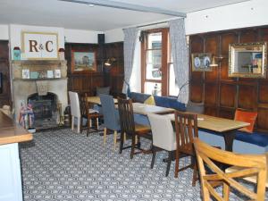 a dining room with a table and chairs and a fireplace at Rose And Crown in Bath +18 photos