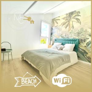 a bedroom with a bed with a beach mural at Jungle, chambre spacieuse au coeur des sables in Les Sables-dʼOlonne