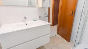 a bathroom with a sink and a shower at Il Giardino Segreto - Italian Homing in Rivoltella +13 photos