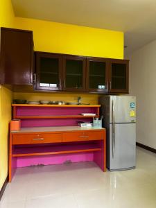 a kitchen with colorful cabinets and a refrigerator at Ao-Nang Private Yellow House 9 in Ao Nang Beach +9 photos