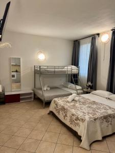 a bedroom with two bunk beds and a mirror at Aparthotel Dergano 2 near metro stop in Milan