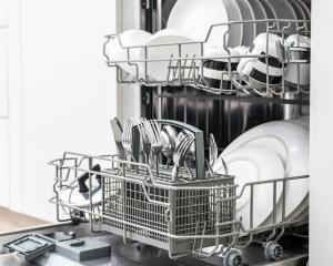 a dishwasher with dishes and dishes in it at Cassa Midas by the forest in Zgornje Jezersko +20 photos