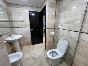 a bathroom with a toilet and a sink at Corniche Casablanca in Casablanca +23 photos