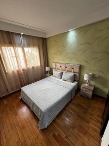 a bedroom with a large bed and a window at Corniche Casablanca in Casablanca