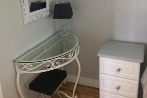 a dressing table with a mirror and a table with a stool at Apartment - Sleeps 2 - Wood Fire - Parking in Cullyhanna +3 photos