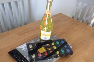 a bottle of alcohol sitting on a table with a remote control at Apartment - Sleeps 2 - Wood Fire - Parking in Cullyhanna
