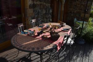 Una mesa con un mantel en un patio. en Chambre d'hôtes La Framboisine, en Bourgvilain