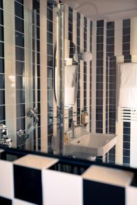 a bathroom with a sink and a mirror at LALA Hôtel in Paris +108 photos