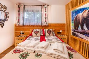 a bedroom with a bed with a picture of a bear at Apartament Pod Magurą in Witów