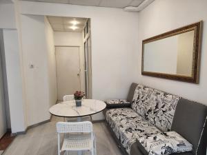 a living room with a couch and a table at Стаи за гости Ве-Бо-Ли** in Bankya