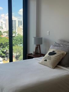 a bedroom with a bed and a large window at Soneto 603 in Guadalajara