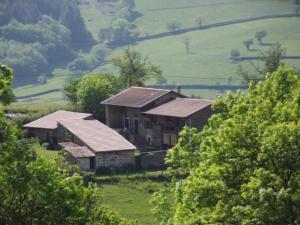 an old house on a hill in a field at Gîte la Framboisine in Bourgvilain