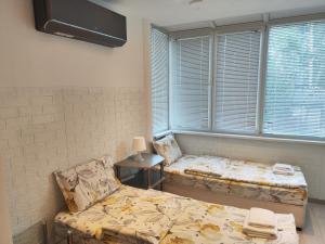 a room with a bed and a chair and a window at Стаи за гости Ве-Бо-Ли** in Bankya +46 photos
