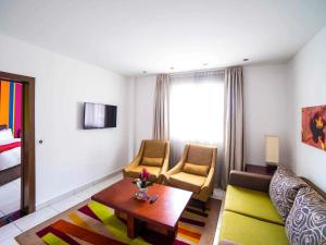 a living room with a couch and a table at Ibis Styles Accra Airport in Accra